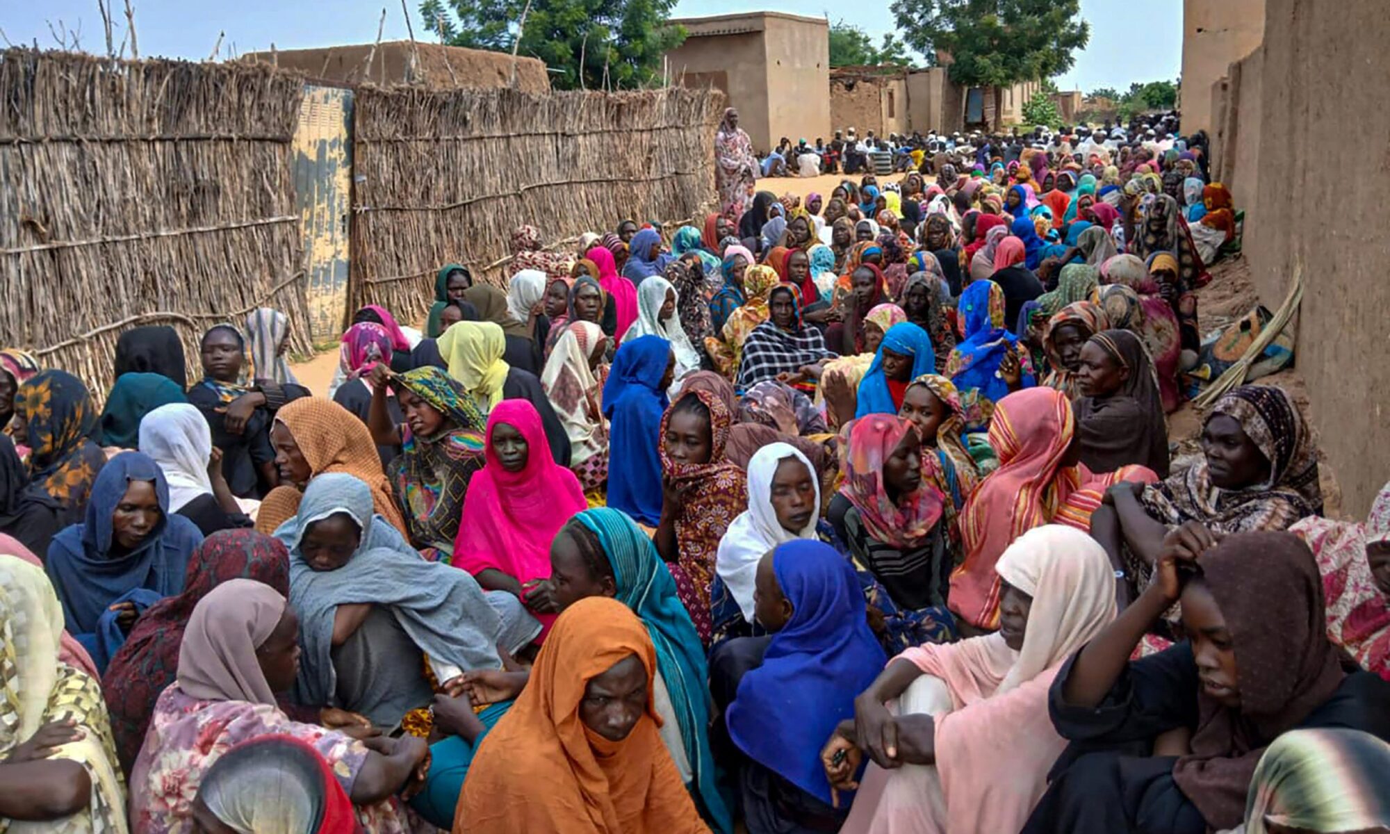 Sudanese residents gather to receive free meals in Al Fasher, a city besieged by Sudan