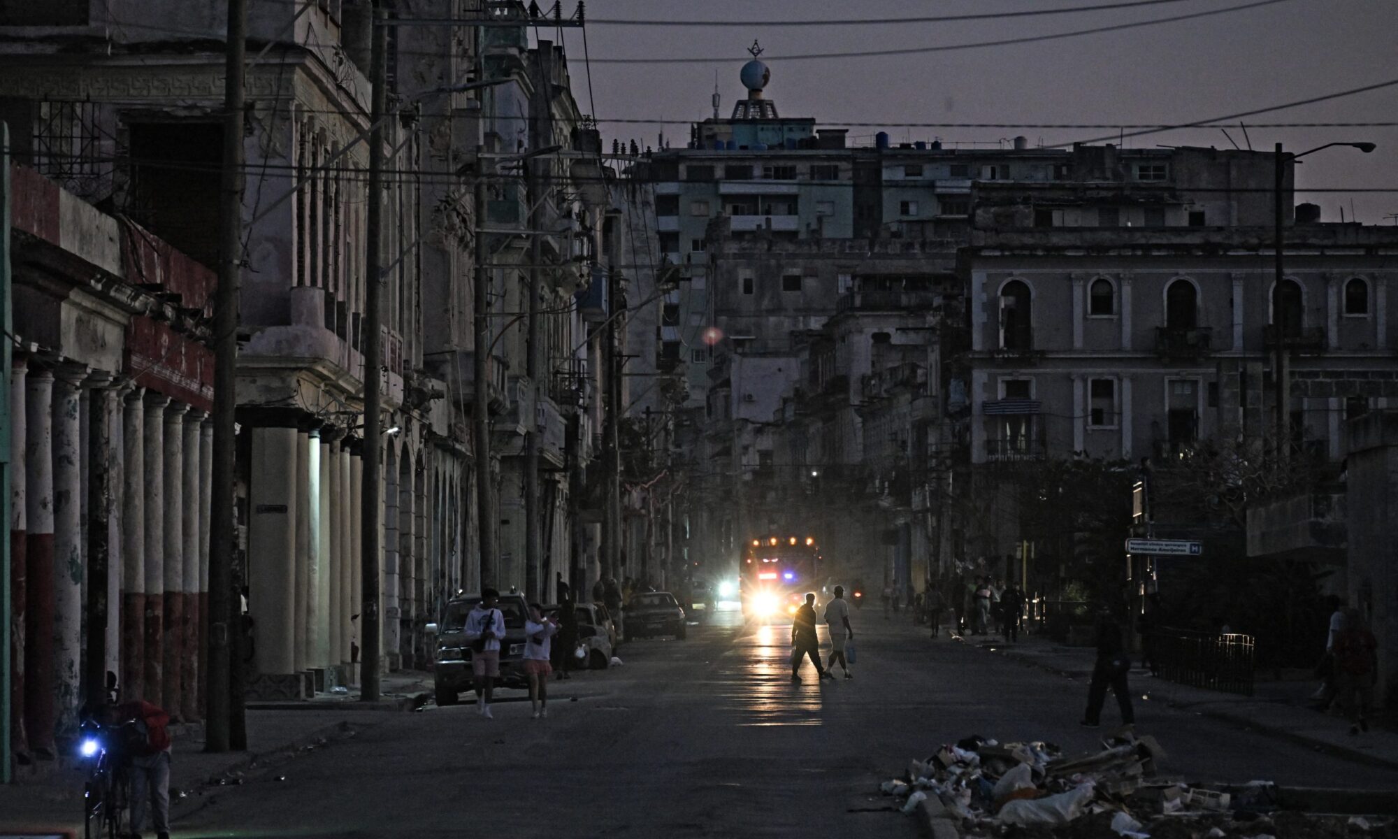 People walk down a street during a blackout in Havana on February 21, 2026.