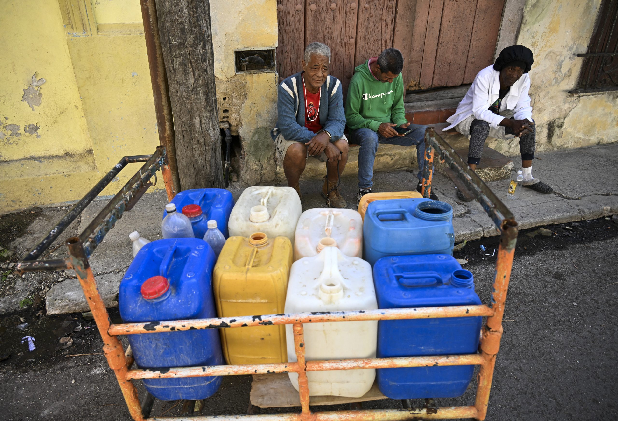 People queue to fill their water containers in Havana during a nationwide blackout on March 22, 2026. Photo by YAMIL LAGE / AFP via Getty Images