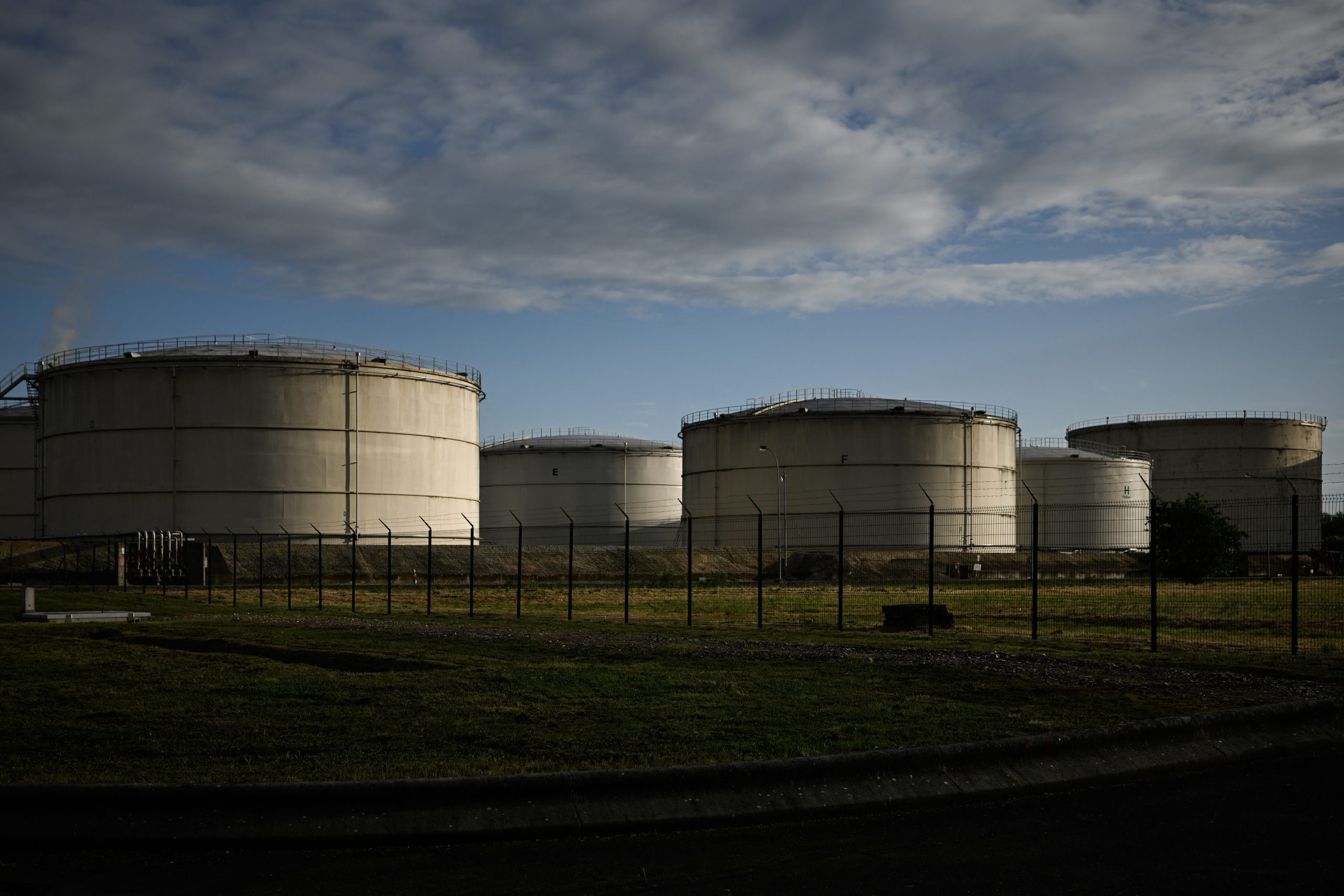 This photograph shows fuel storage tanks loom at a petroleum depot, as global oil supply chains face acute disruption in Ambes, near Bordeaux, south-western France, on May 5, 2026. Photo by Philippe LOPEZ / AFP via Getty Images